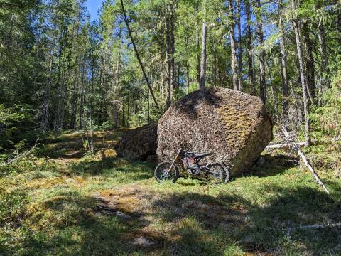 Sur Ron next to large rock