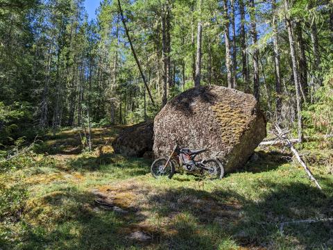 Sur Ron next to large rock