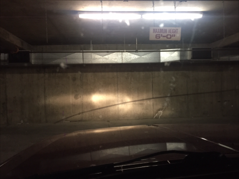 Stock sealed beams shining in underground lot. Super dim.